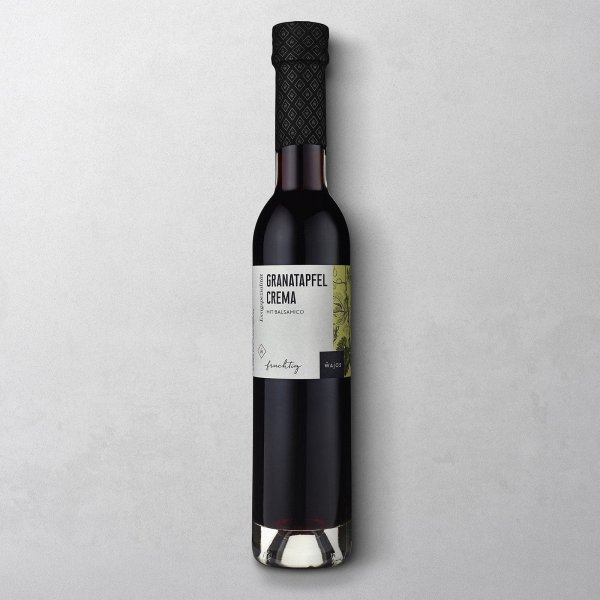 Wajos Granatapfel Crema in der Glasflasche mit schwarzem Verschluss und weißem Etikett
