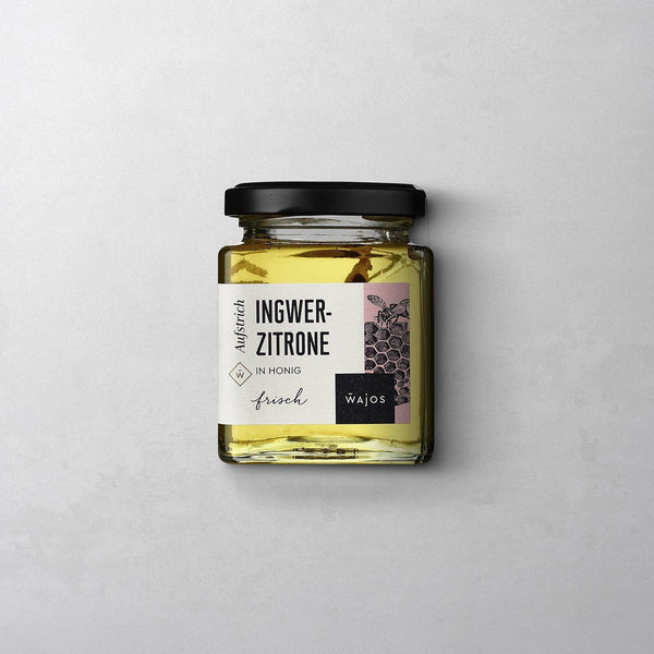 Wajos Honig Ingwer Zitrone im eckigen Schraubglas mit schwarzem Deckel und weißem Etikett