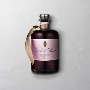 Wajos Elixier D'Amout in schöner Glasflasche mit goldenem Band und rosafarbigem Etikett