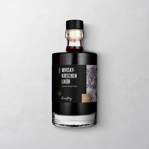 Wajos Whiskey-Kirschen Likör in dekorativer Glasflasche mit schwarzem Etikett und schwarzem Verschluss